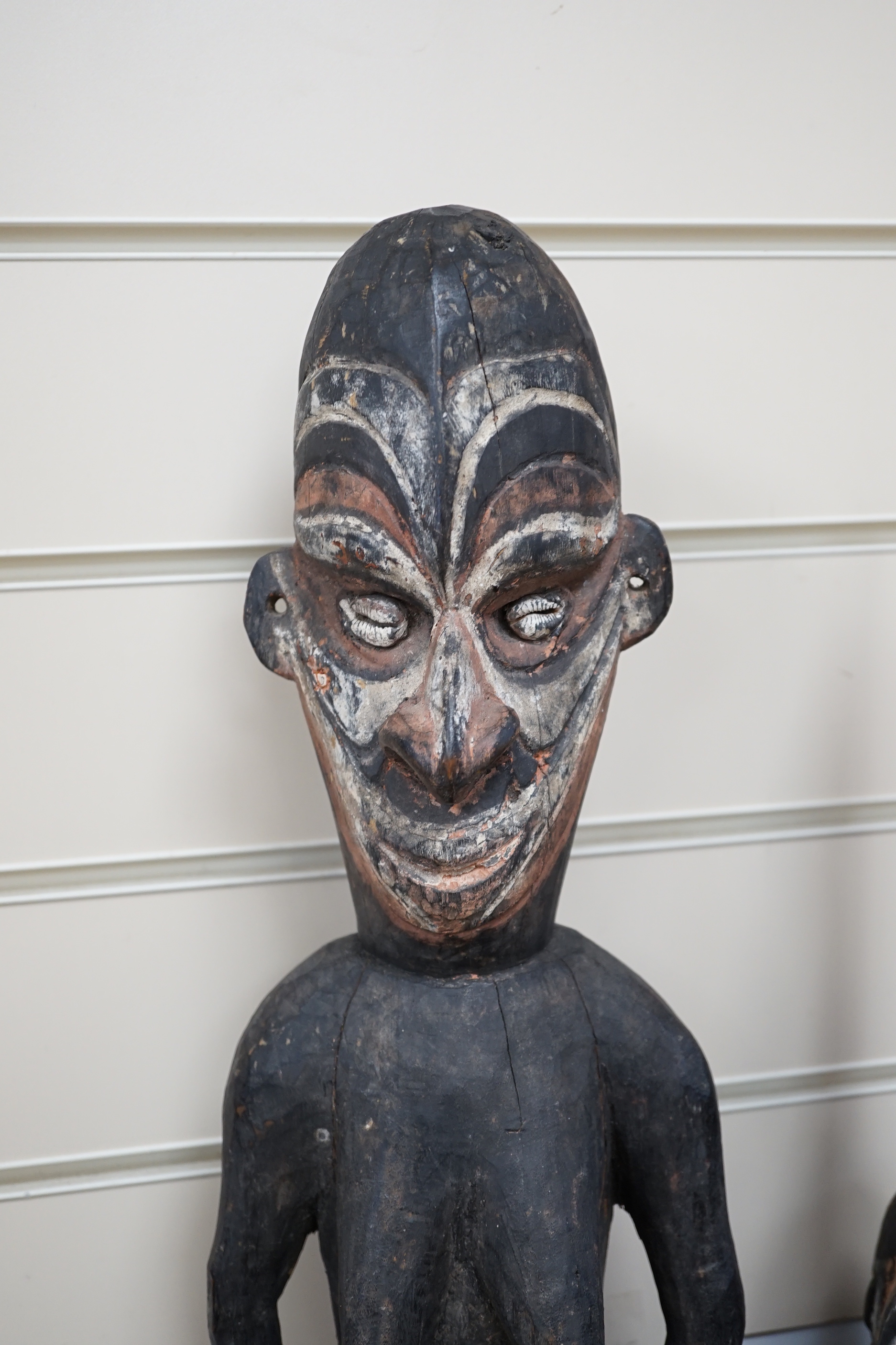 A collection of tribal carvings and masks mostly from Papa New Guinea, largest painted straw mask 86cm high